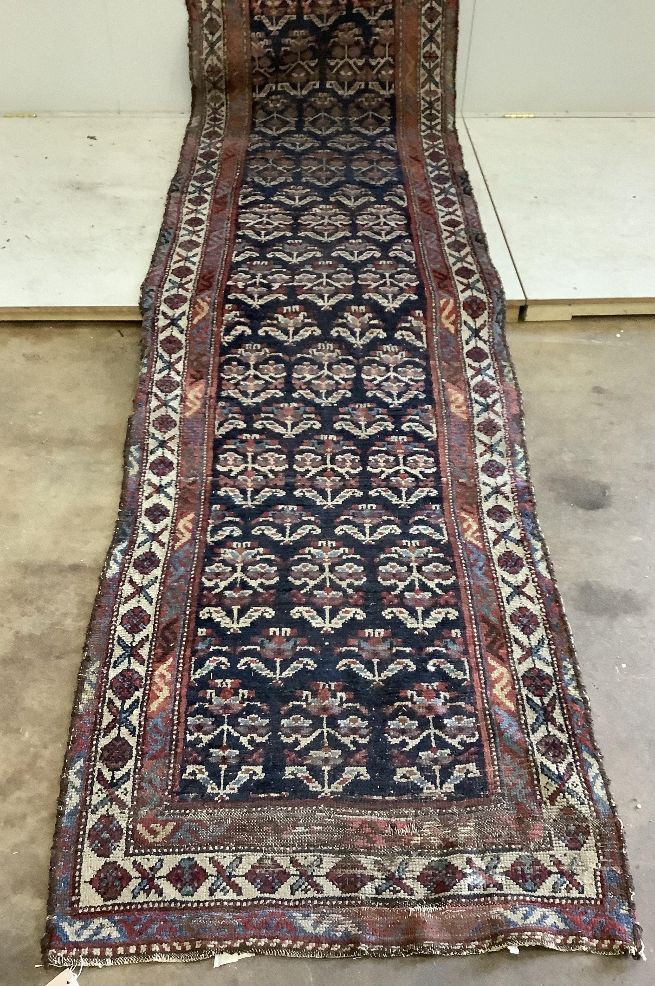 An antique Caucasian blue ground runner, approximately 500 x 91cm. Condition - poor